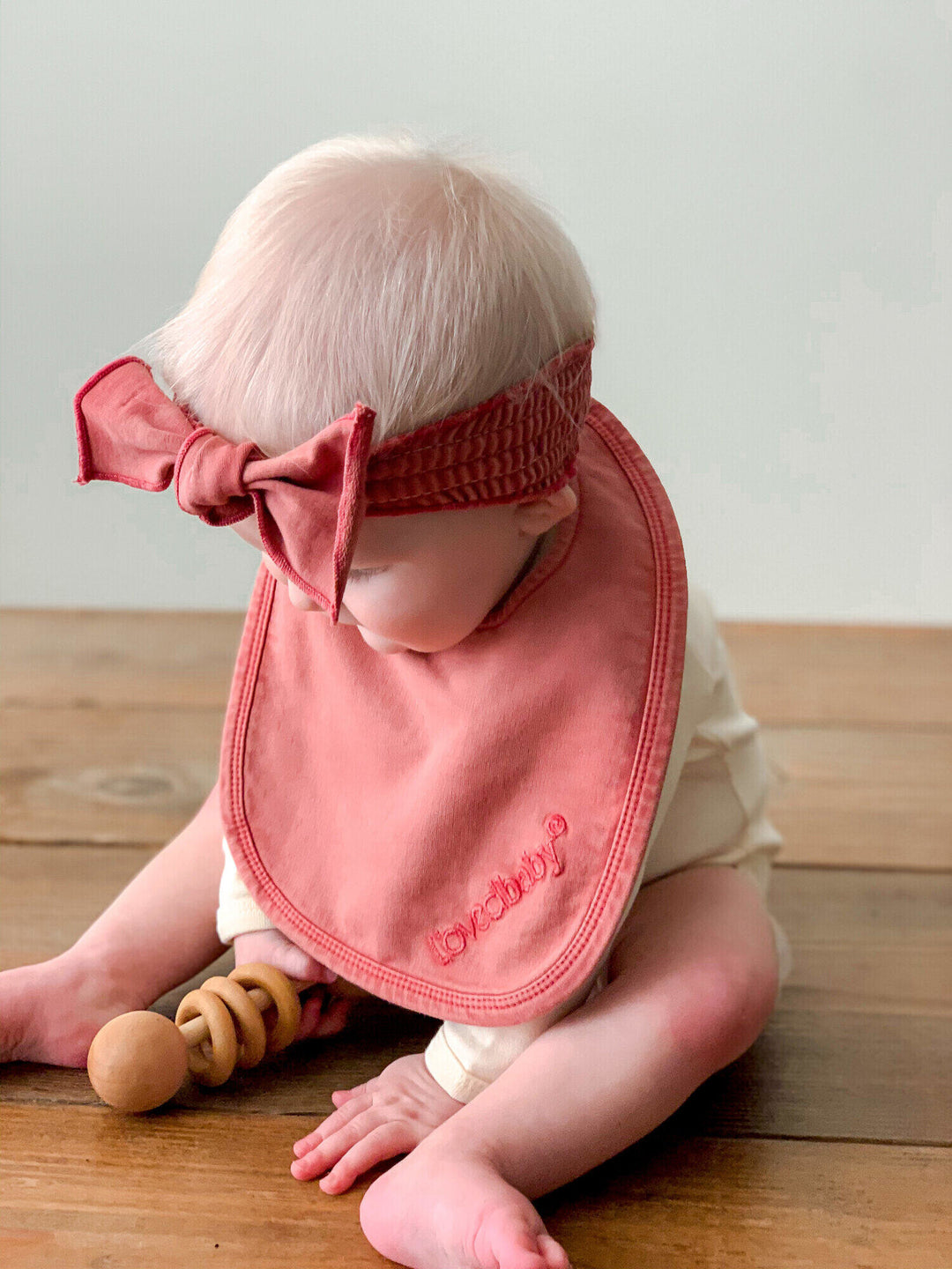 Child wearing Faux Denim Bib in Sienna.