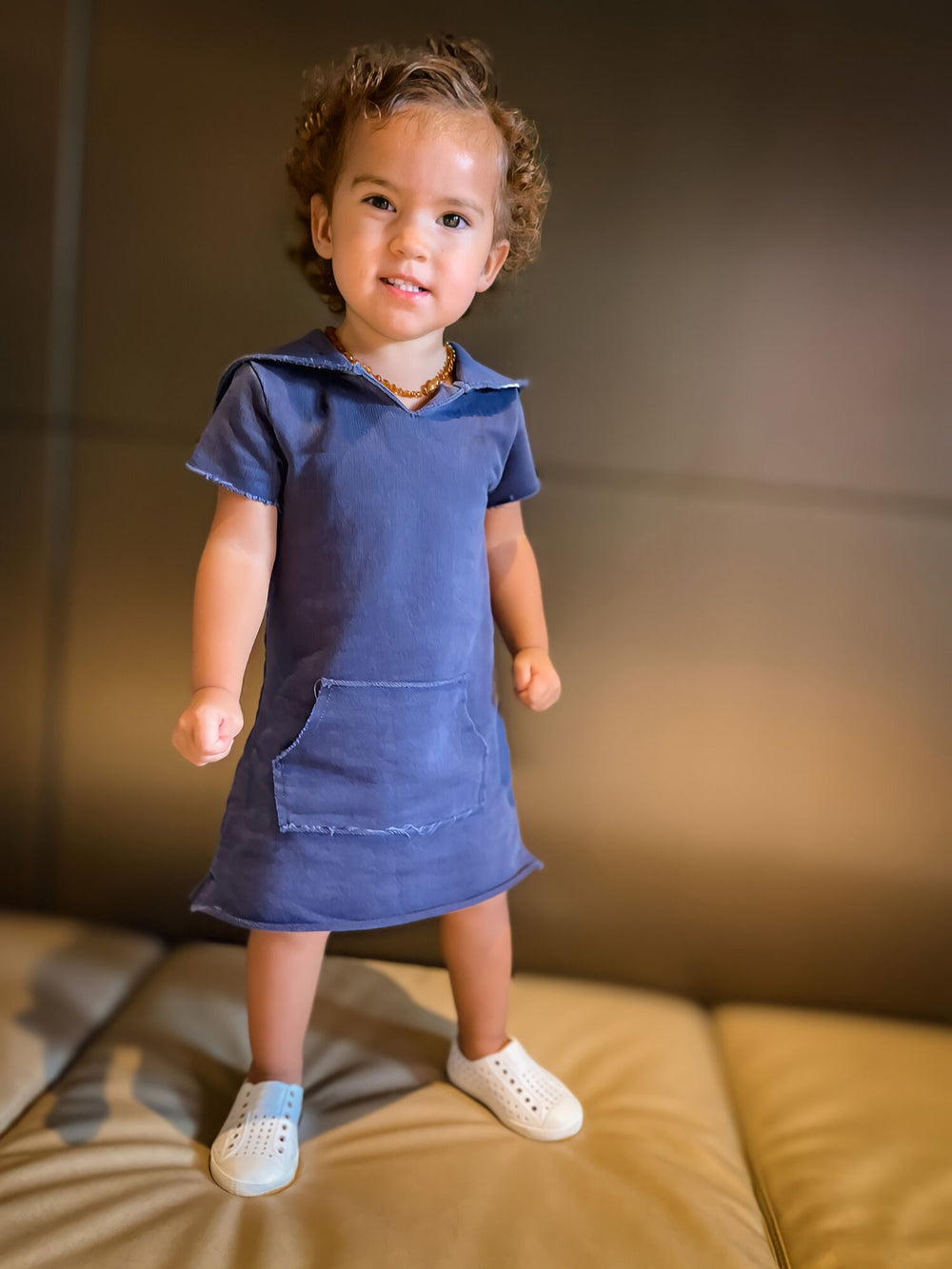 Child wearing Kids' French Terry Hoodie Dress in Indigo.