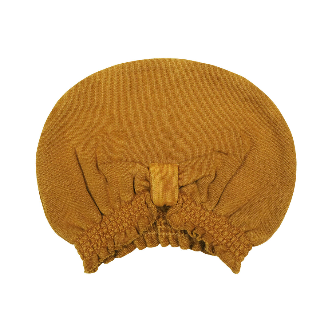 French Terry Knotted Turban in Butterscotch, a yellowish orange color.