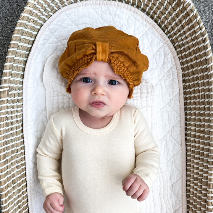 Child wearing French Terry Knotted Turban in Butterscotch.