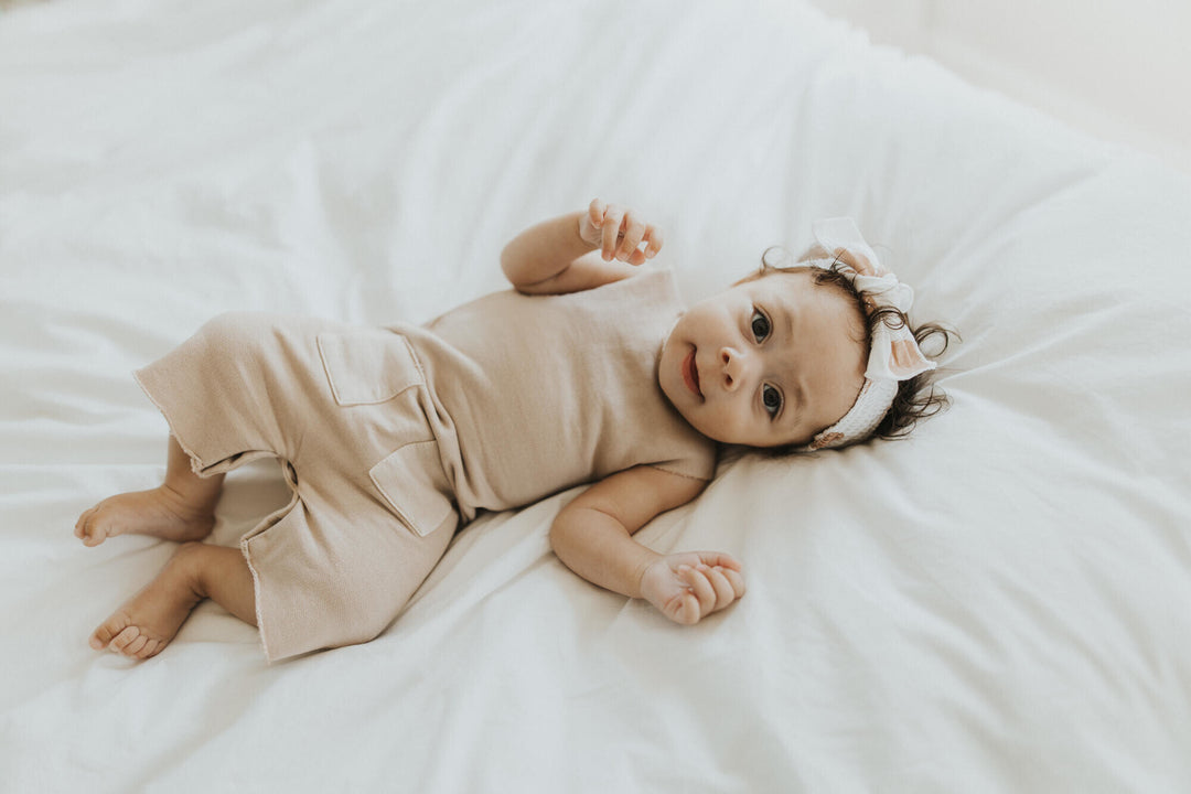 Child wearing French Terry 2-Sided Romper in Oatmeal.