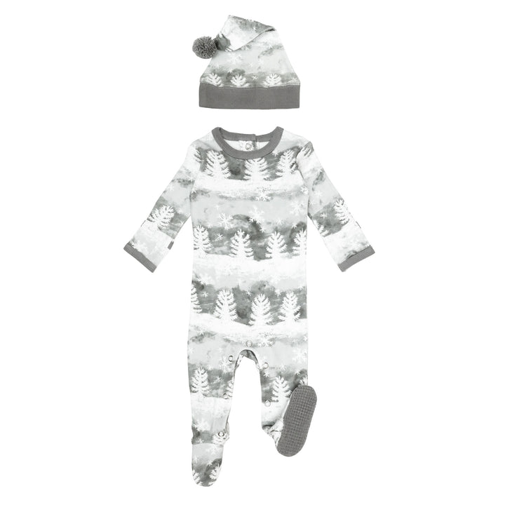 Organic Holiday Footie & Cap Set in Winter Wonderland, a white base fabic with greenish gray trees.