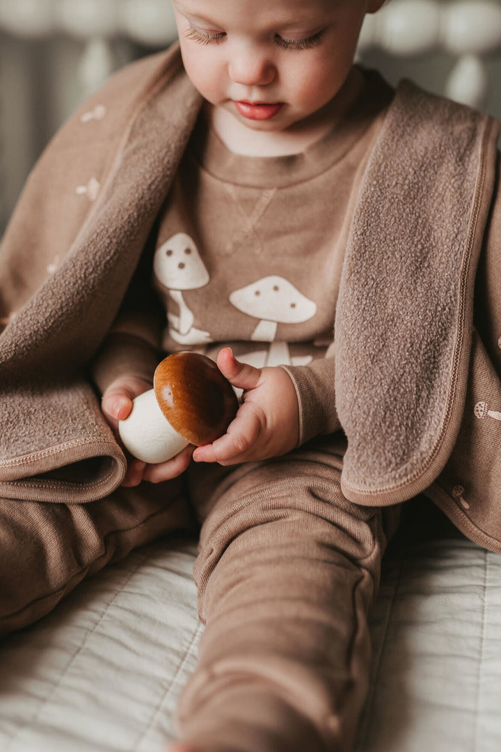 Child wearing Kids' Organic Cozy Graphic Sweatshirt & Jogger Set in Umber Mushroom.