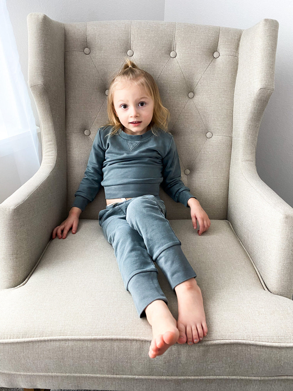 Child wearing Kids' French Terry Sweatshirt & Jogger Set in Moonstone.