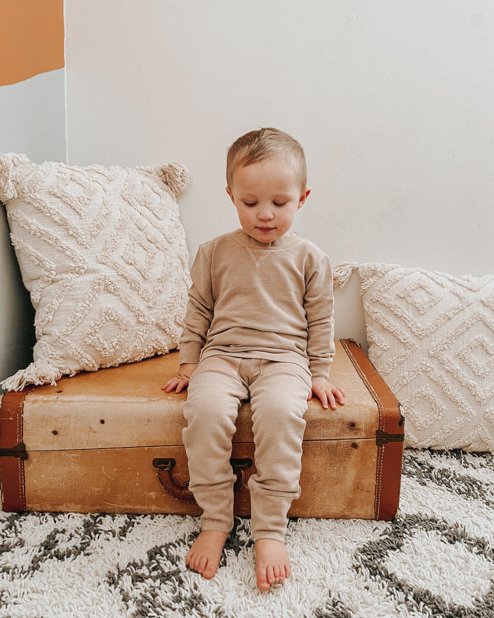 Child wearing Kids' French Terry Sweatshirt & Jogger Set in Oatmeal.