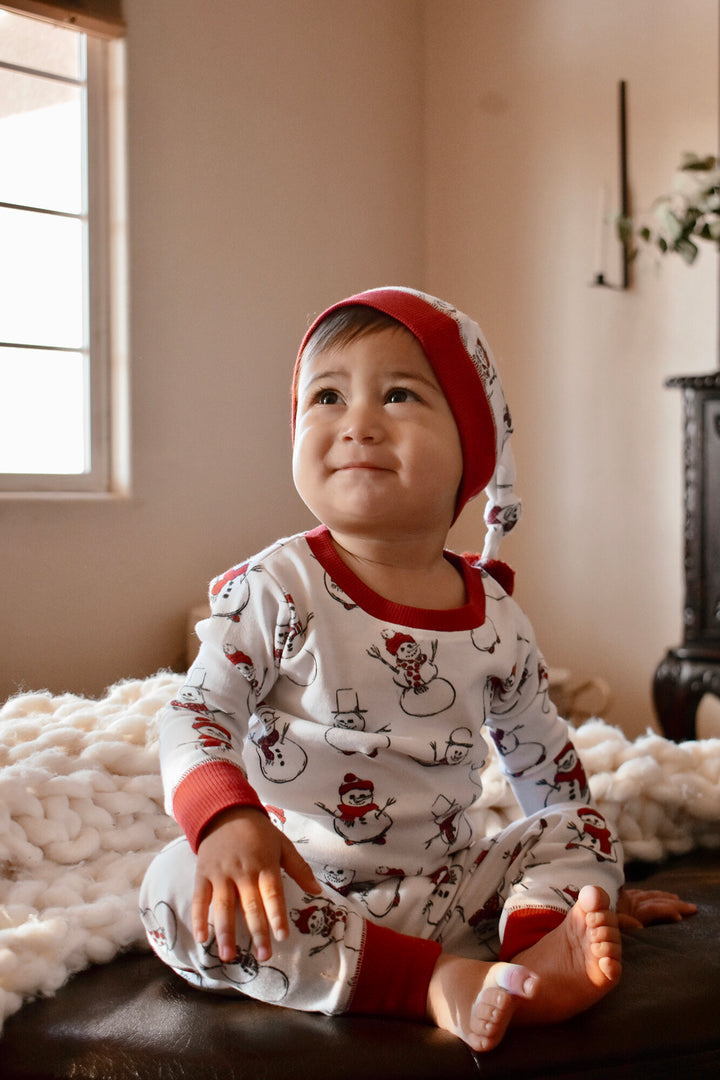 Child wearing Kids' Organic Holiday PJ & Cap Set in Snow Day.