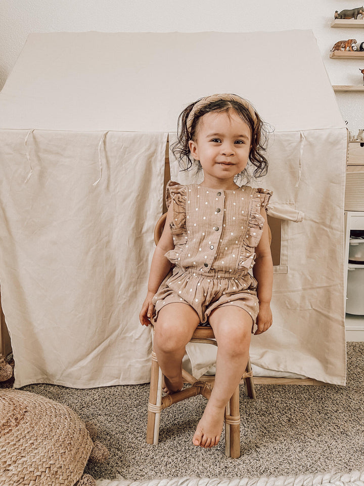 Child wearing Embroidered Muslin Ruffle Jumper in Wheat Dot.