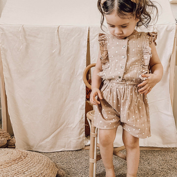 Child wearing Embroidered Muslin Ruffle Jumper in Wheat Dot.