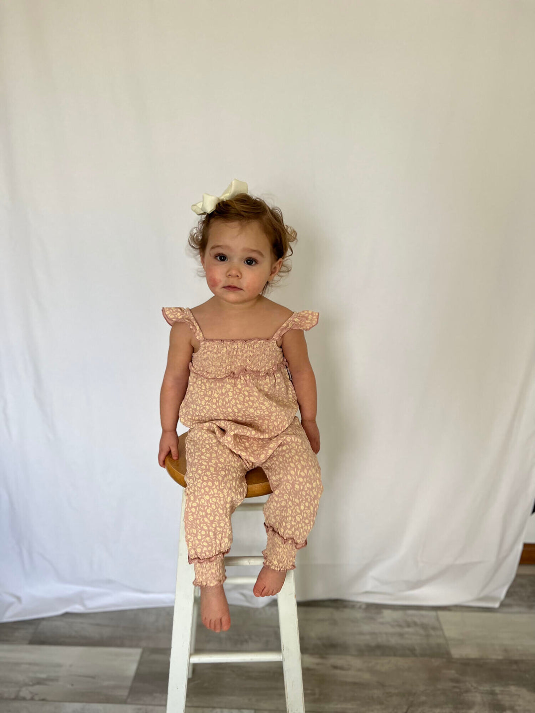 Child wearing Printed Muslin Sleeveless Romper in Carnation Floral.