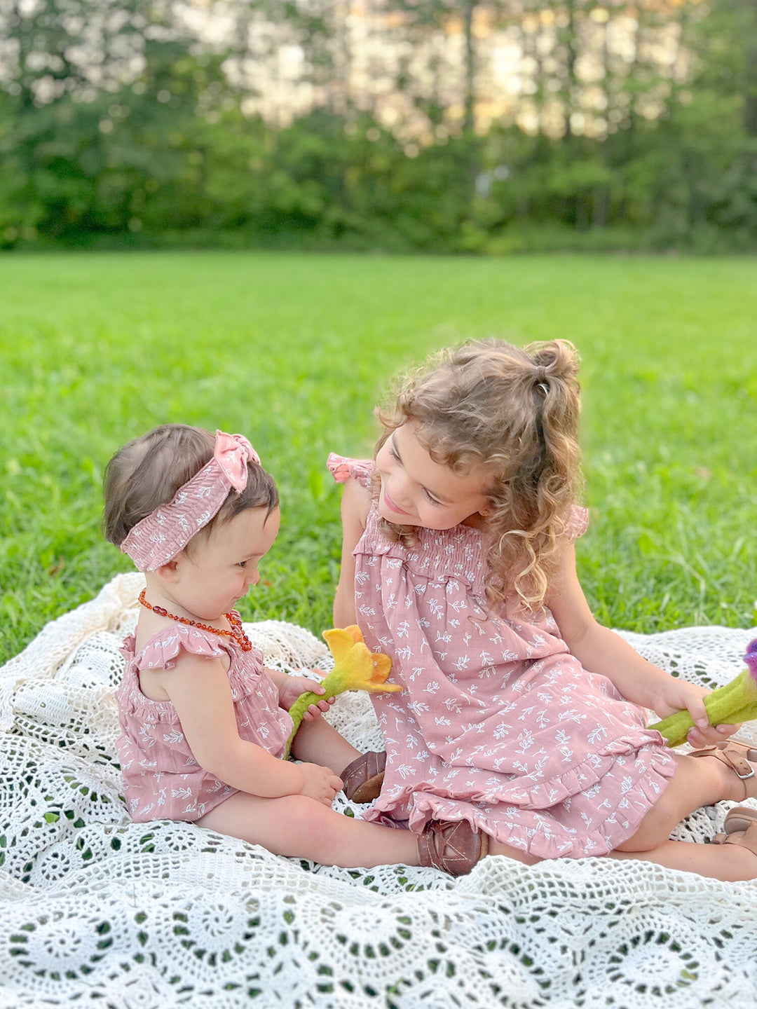 Child wearing Kids' Organic Muslin Summer Dress in Desert Rose Leaves.