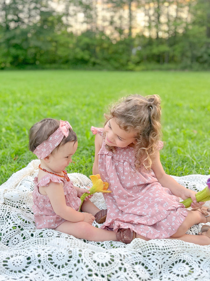 Child wearing Kids' Organic Muslin Summer Dress in Desert Rose Leaves.