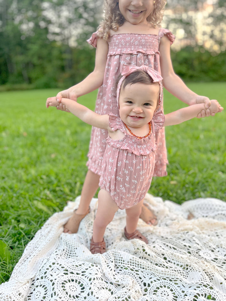 Child wearing Kids' Organic Muslin Summer Dress in Desert Rose Leaves.