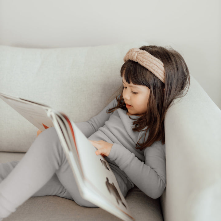 Child wearing Organic Kids' L/Sleeve PJ Set in Light Gray.