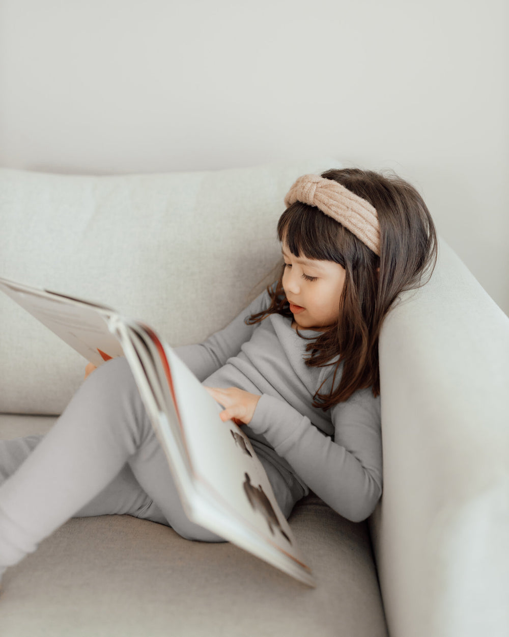 Child wearing Organic Kids' L/Sleeve PJ Set in Light Gray.