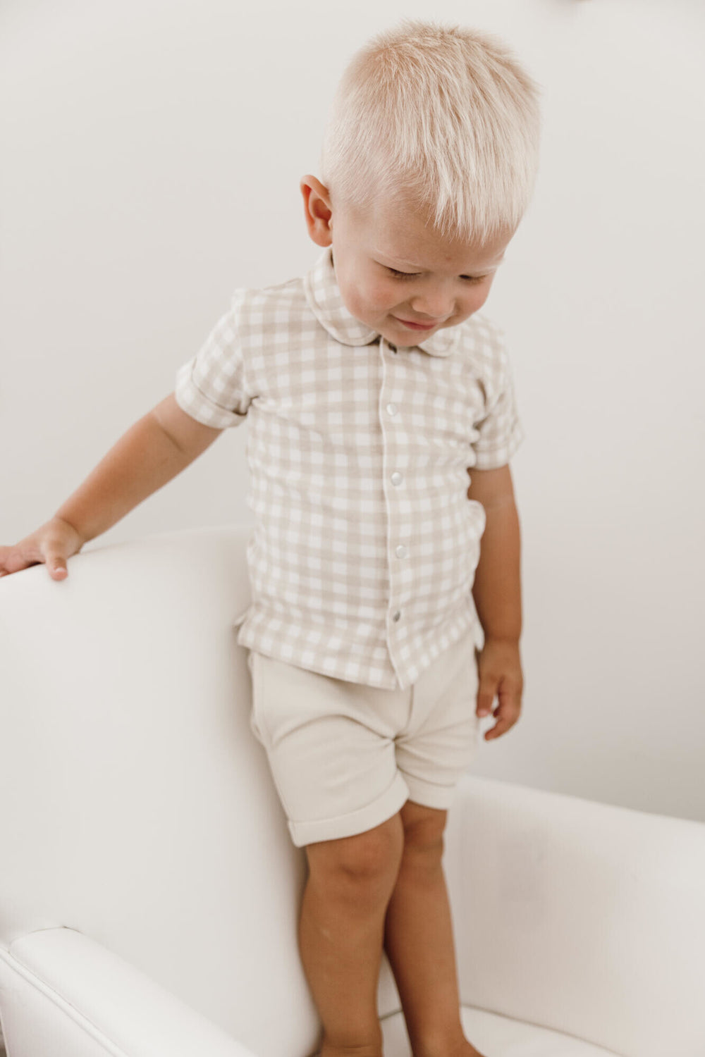Child wearing Kids' Cuffed Shorts in Stone.