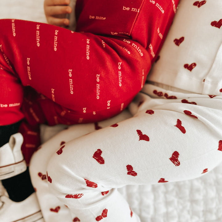 Child wearing Kids' Organic L/Sleeve PJ Set in Crimson Hearts.