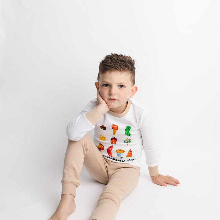 Child wearing Kids' Organic L/Sleeve PJ Set in Happy Day.