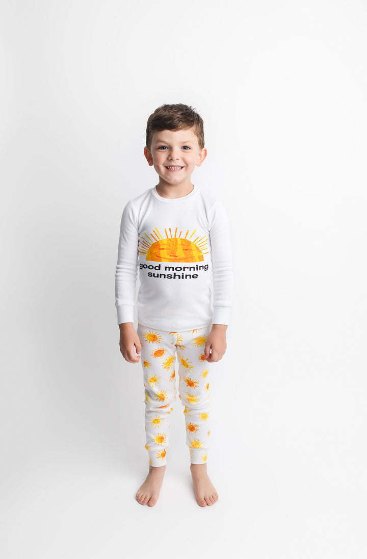 Child wearing Kids' Organic L/Sleeve PJ Set in Sunny Day.