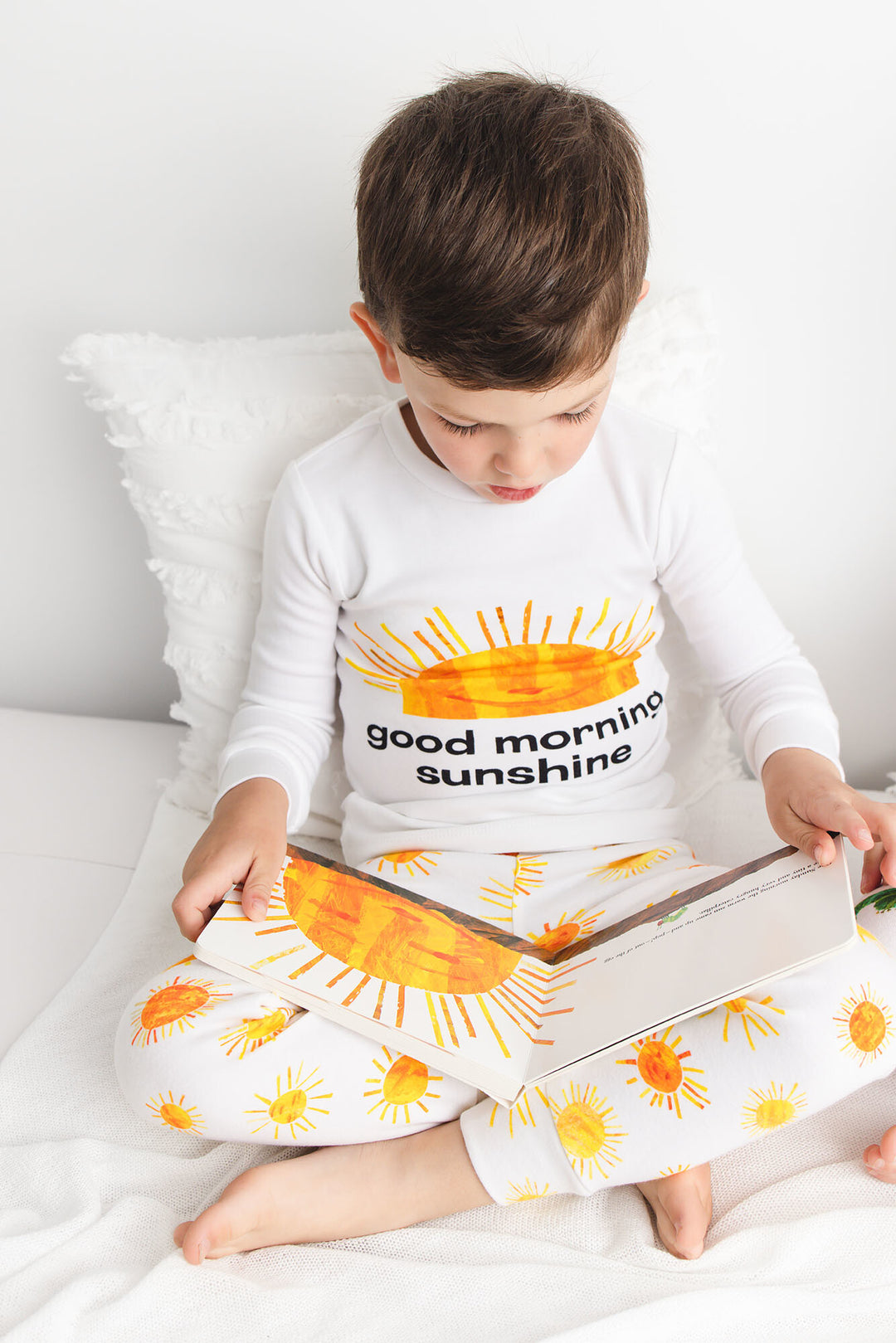 Child wearing Kids' Organic L/Sleeve PJ Set in Sunny Day.