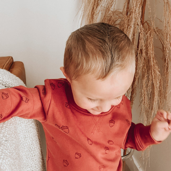 Child wearing Kids' Printed Sweatshirt & Jogger Set in Spice Acorn.