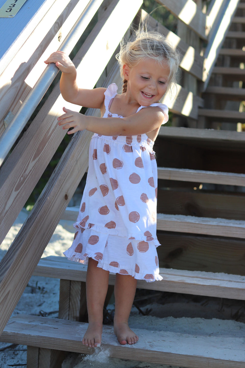 Child wearing Kids' Slub Jersey Smocked Summer Dress in Adobe Dot.
