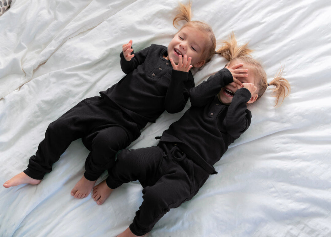 Child wearing Organic Thermal Kids' Lounge Set in Black.