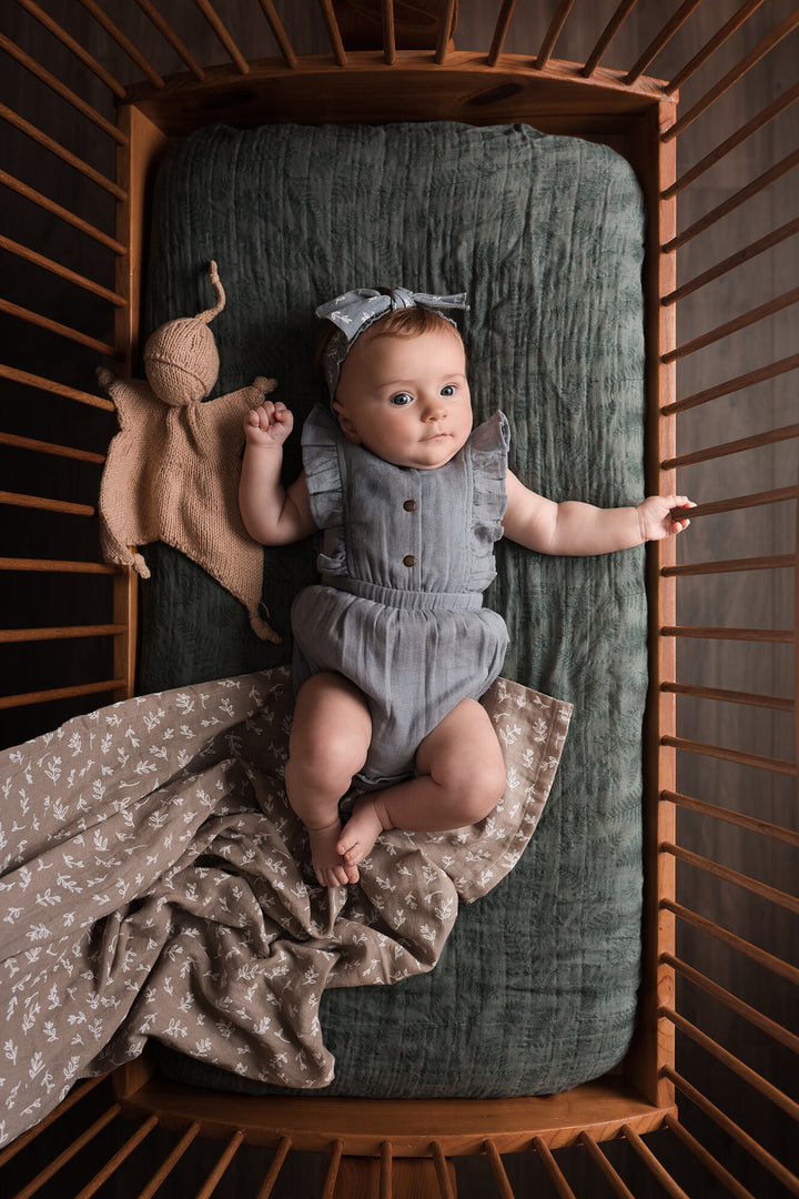 Child wearing Organic Muslin Ruffle Bodysuit in Twilight.