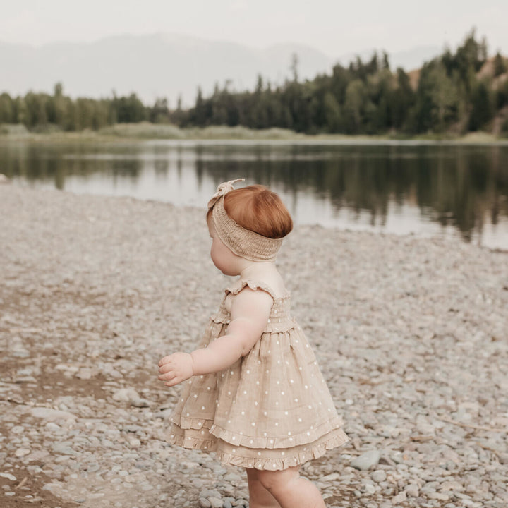 Child wearing Embroidered Muslin Summer Dress in Wheat Dot.