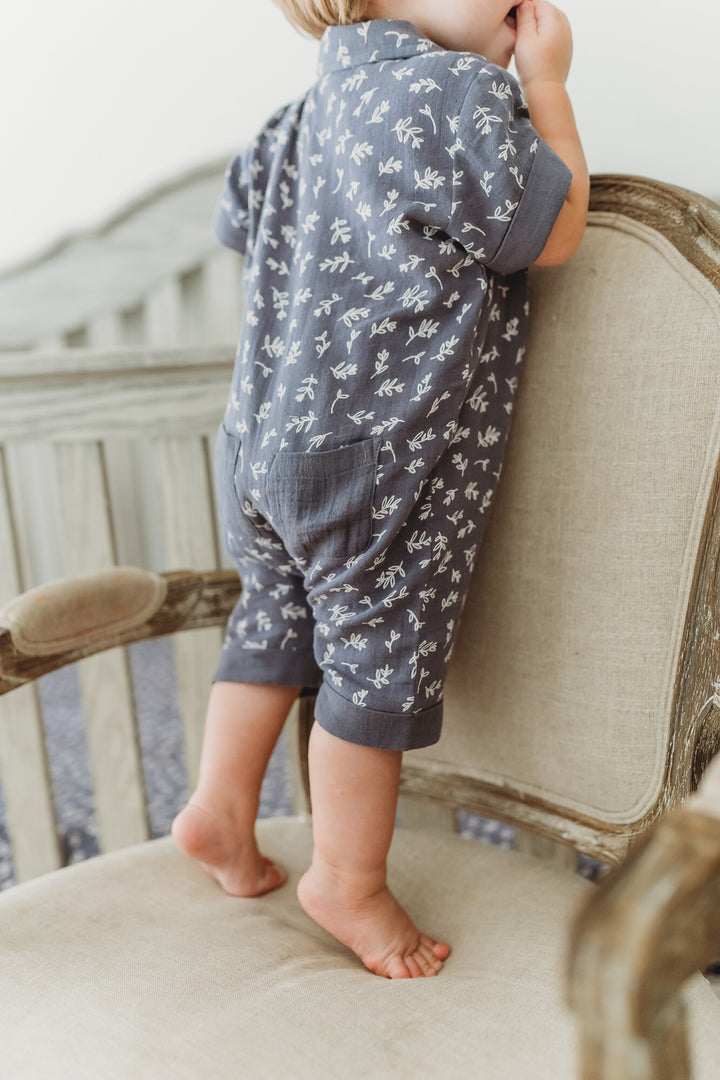 Child wearing Organic Muslin S/Sleeve Coverall in Dusk Leaves.