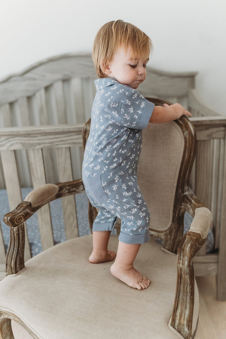 Child wearing Organic Muslin S/Sleeve Coverall in Twilight Leaves.