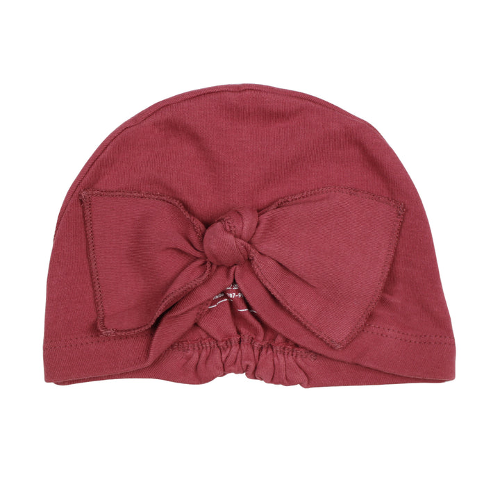 Knotted Turban in Appleberry, a dark, dusky pink color.