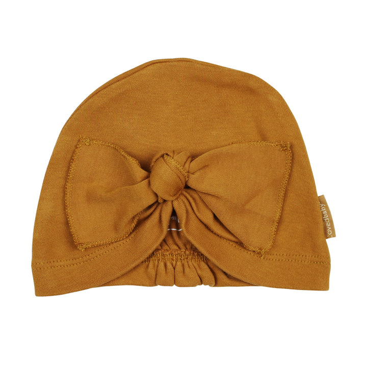 Knotted Turban in Butterscotch, a yellowish orange color.