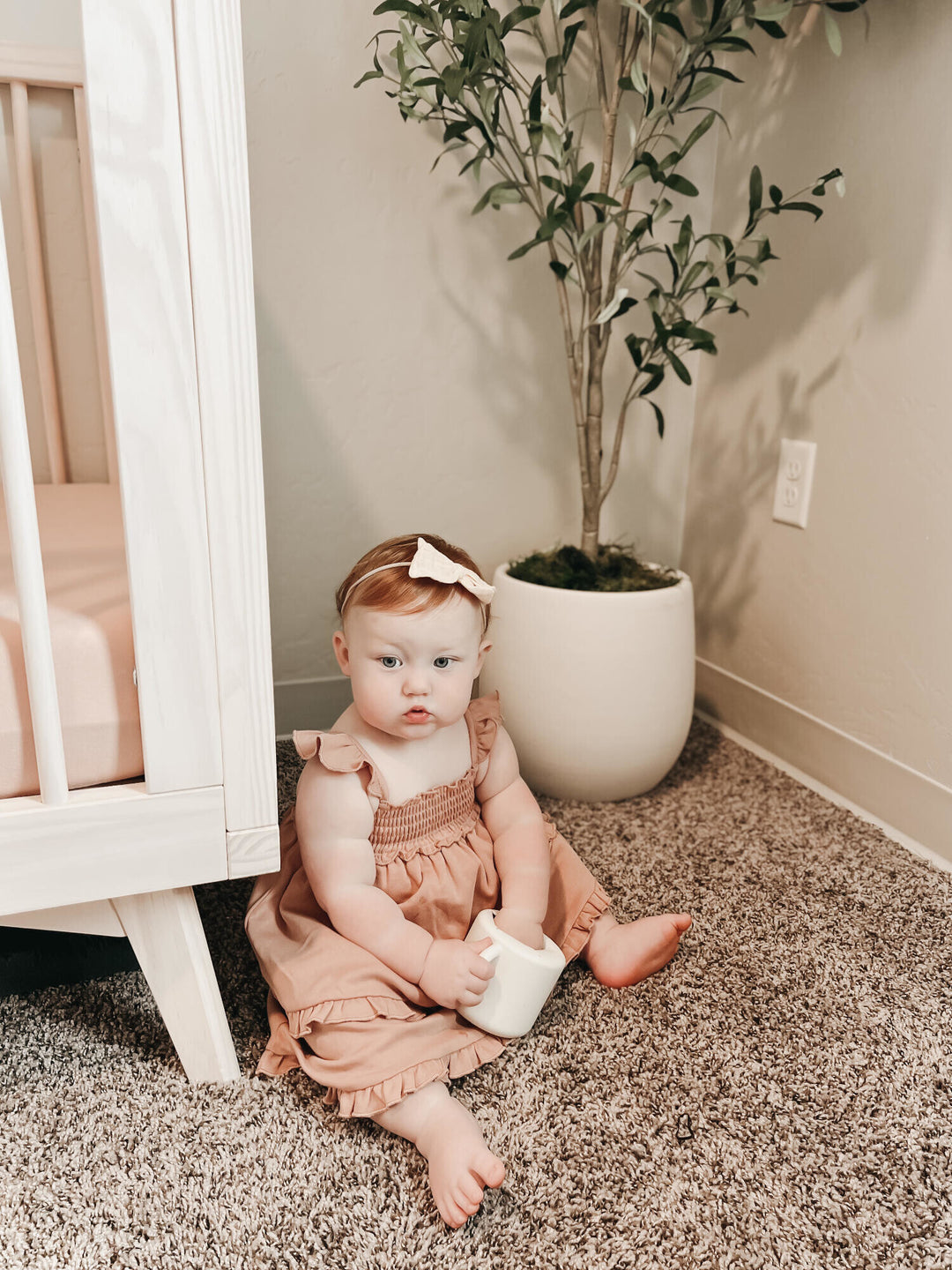 Child wearing Smocked Summer Dress in Adobe.