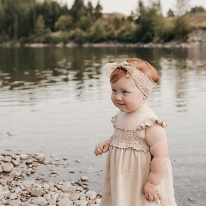 Child wearing Smocked Summer Dress in Oatmeal.