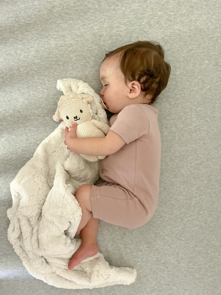 Child wearing Organic Short-Sleeve Romper in Pinks.