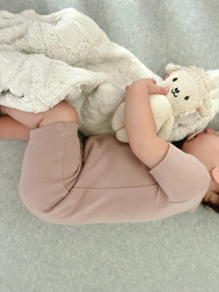 Child wearing Organic Short-Sleeve Romper in Pinks.