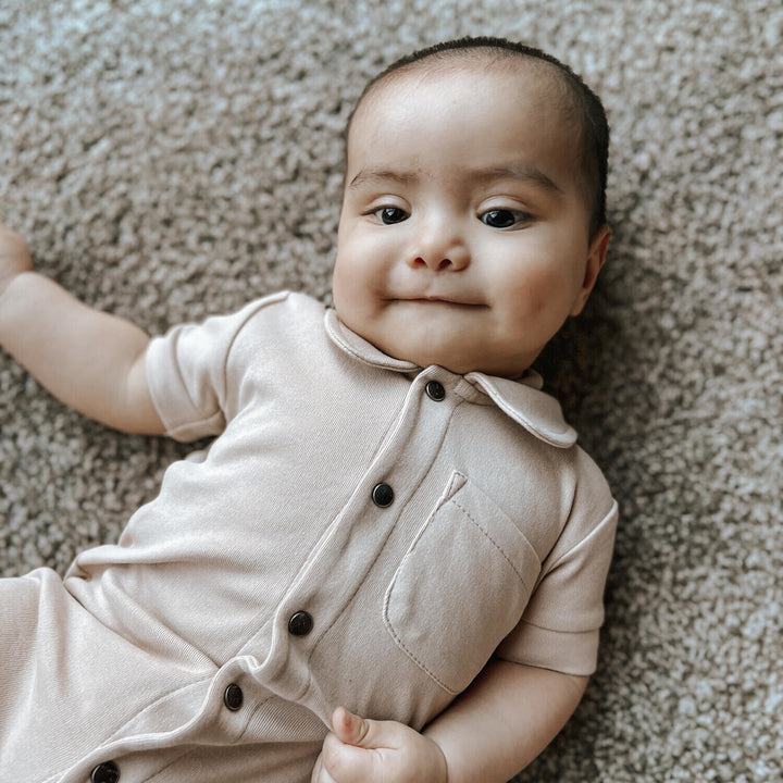 Child wearing S/Sleeve Coverall in Oatmeal.