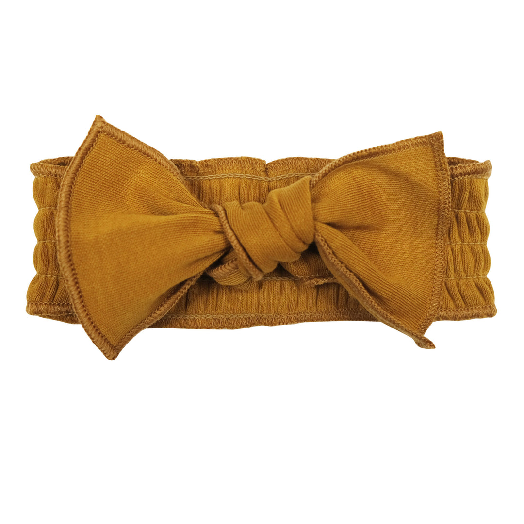 Organic Smocked Tie Headband in Butterscotch, a yellowish orange color.