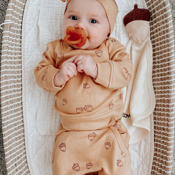 Child wearing Organic Cotton Lovey in Buttercream.