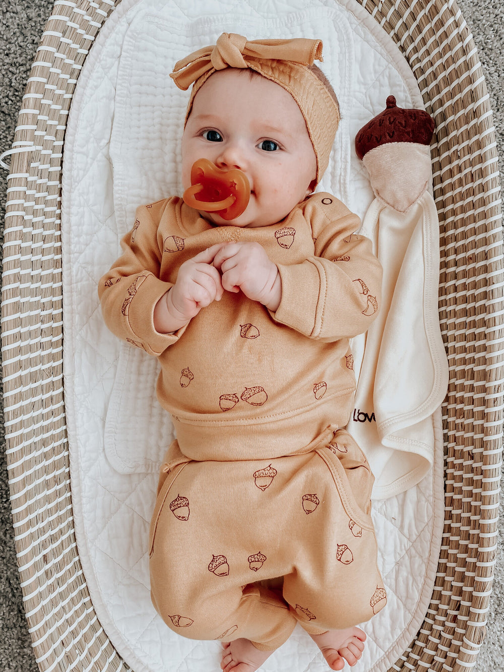 Child wearing Organic Cotton Lovey in Buttercream.