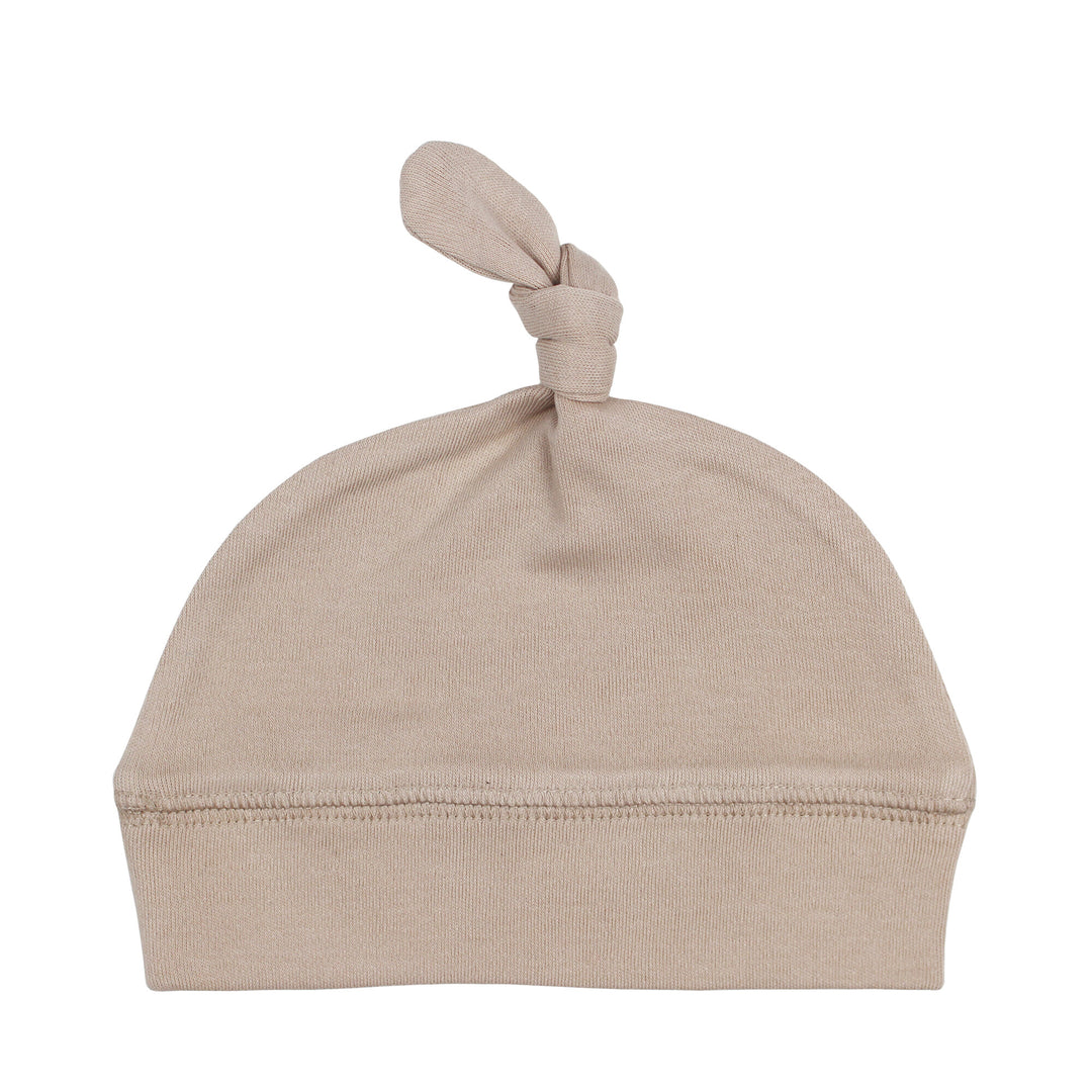 Top-Knot Hat in Oatmeal, a light tan color.