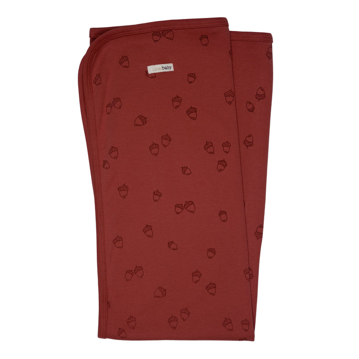 Organic Swaddling Blanket, Print in Spice Acorn, a reddish brown fabric with brown printed acorns.