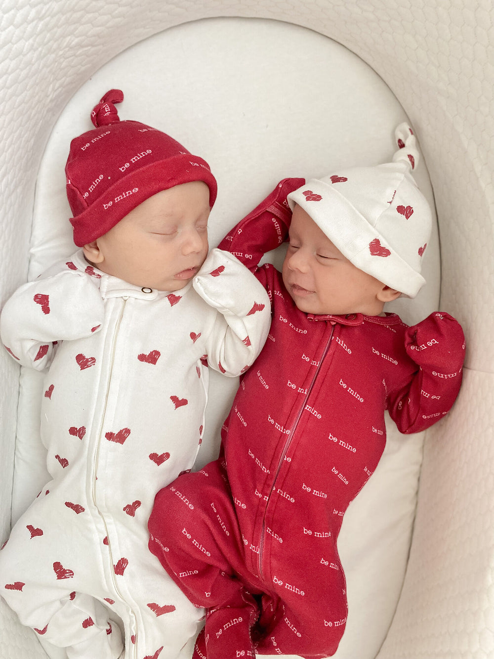Child wearing Organic Banded Top-Knot Hat in Crimson Hearts.