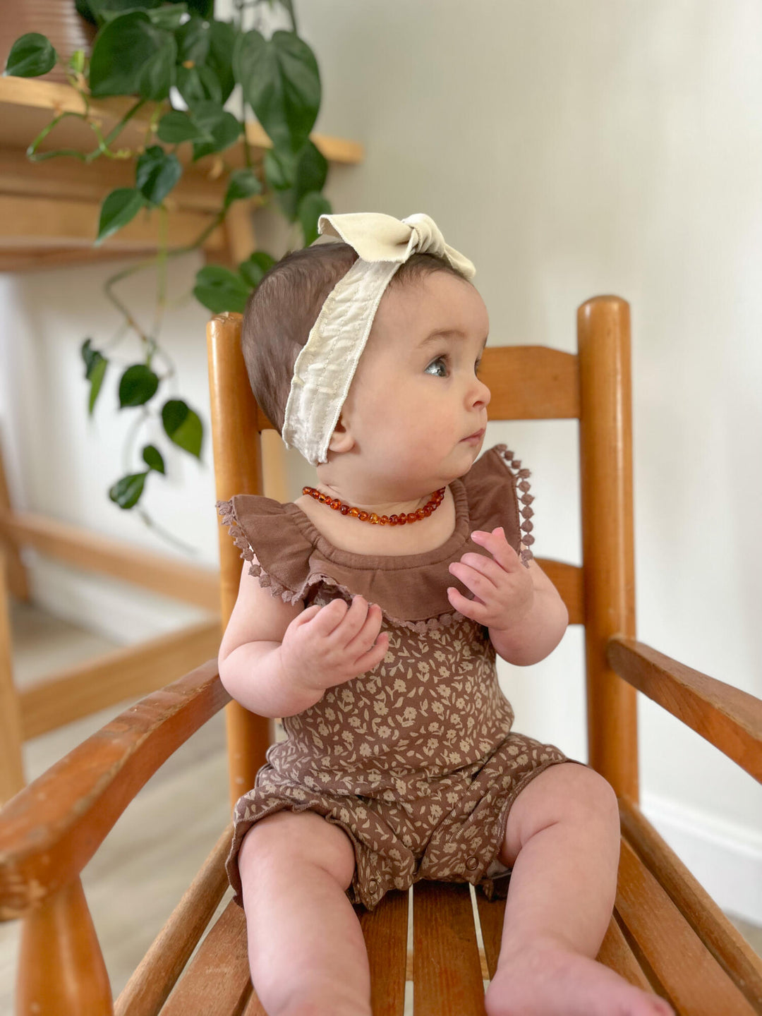 Child wearing Printed Bubble Romper in Latte Floral. 