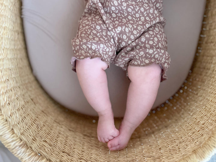 Child wearing Printed Bubble Romper in Latte Floral. 