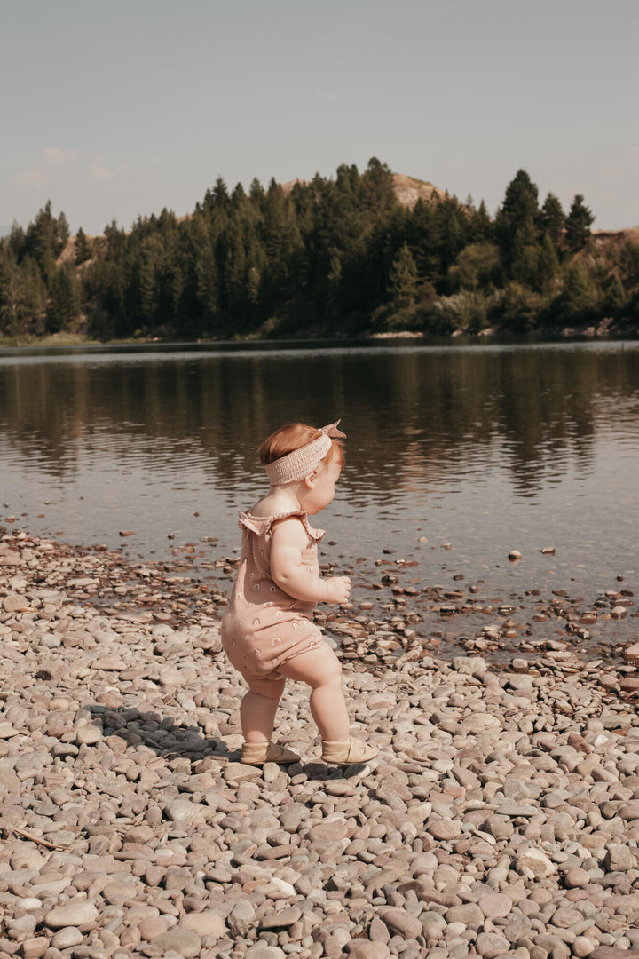 Child wearing Printed Bubble Romper in Mauve Rainbow.
