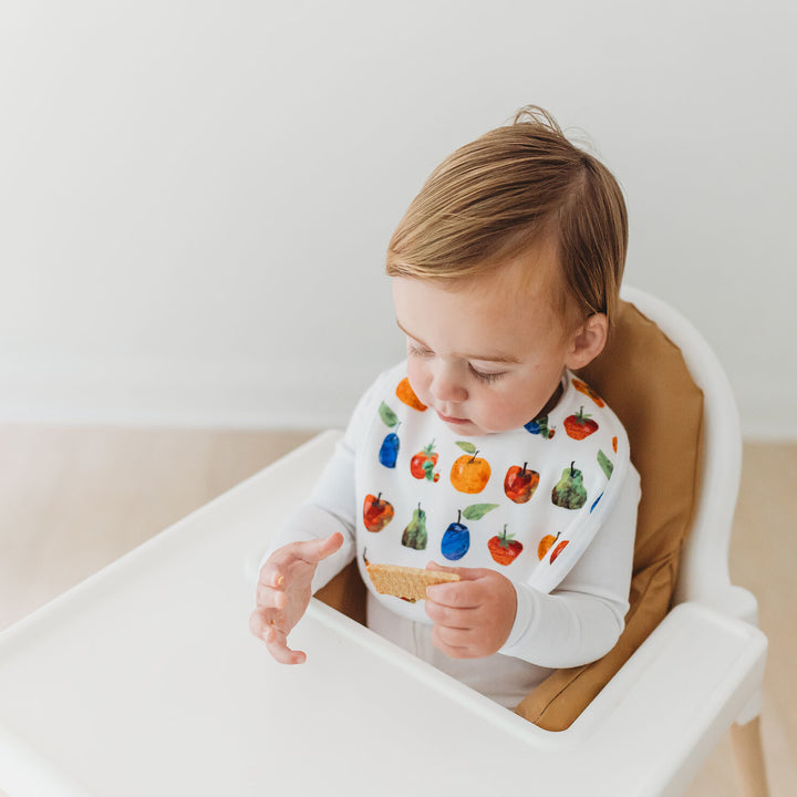 Child wearing Organic 2-Layer Reversible Bib in Fruit.