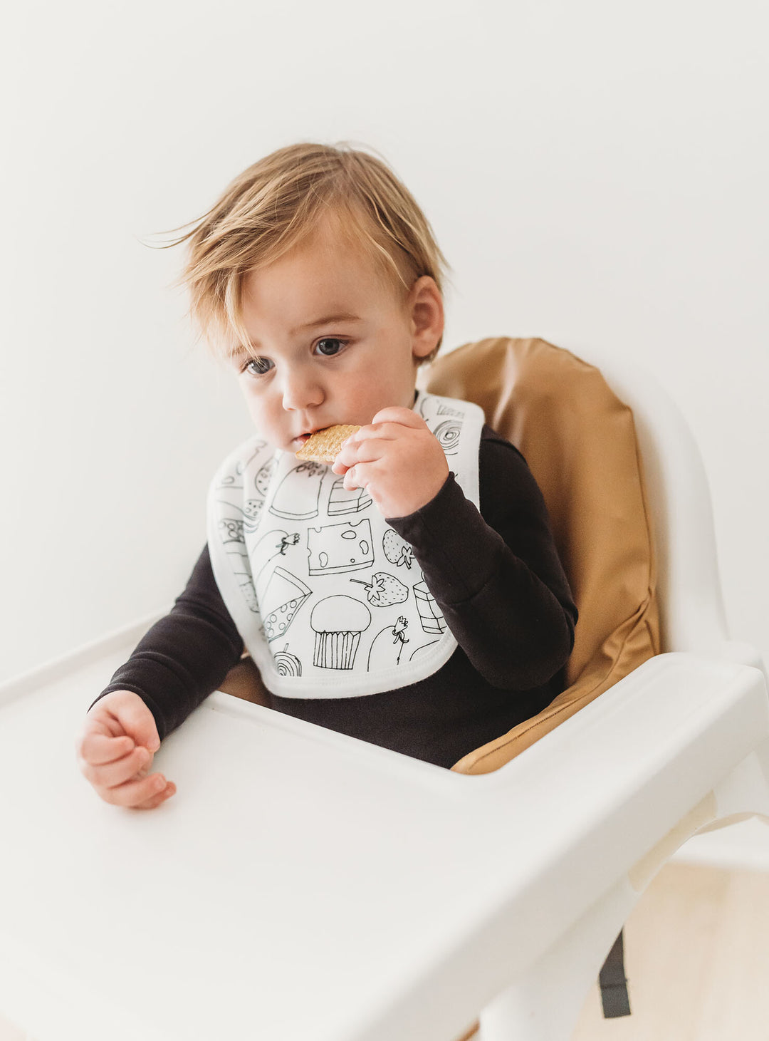 Child wearing Organic 2-Layer Reversible Bib in Snacks.