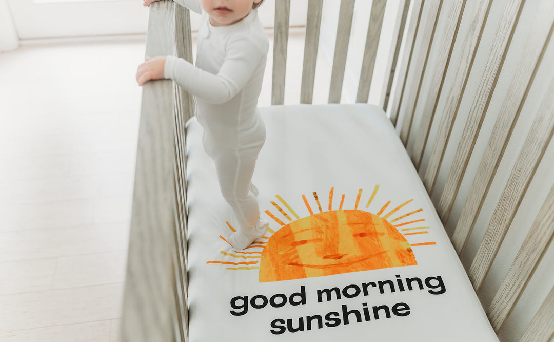 Child wearing Organic Crib Sheet 2-Pack in Sunny Day.