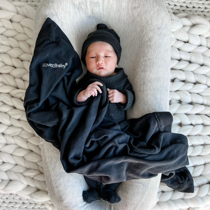 Child wearing Organic Pique Blanket in Black.